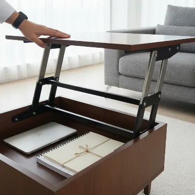 Close-up of a hand smoothly lifting a modern lift-top coffee table, showing the mechanism and hidden storage inside, with a laptop partially visible